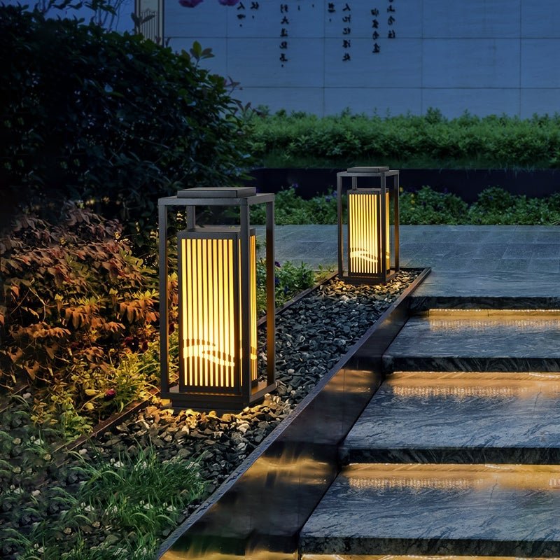 Garden bollards lights with a close-up of their vertical slats and warm glow.