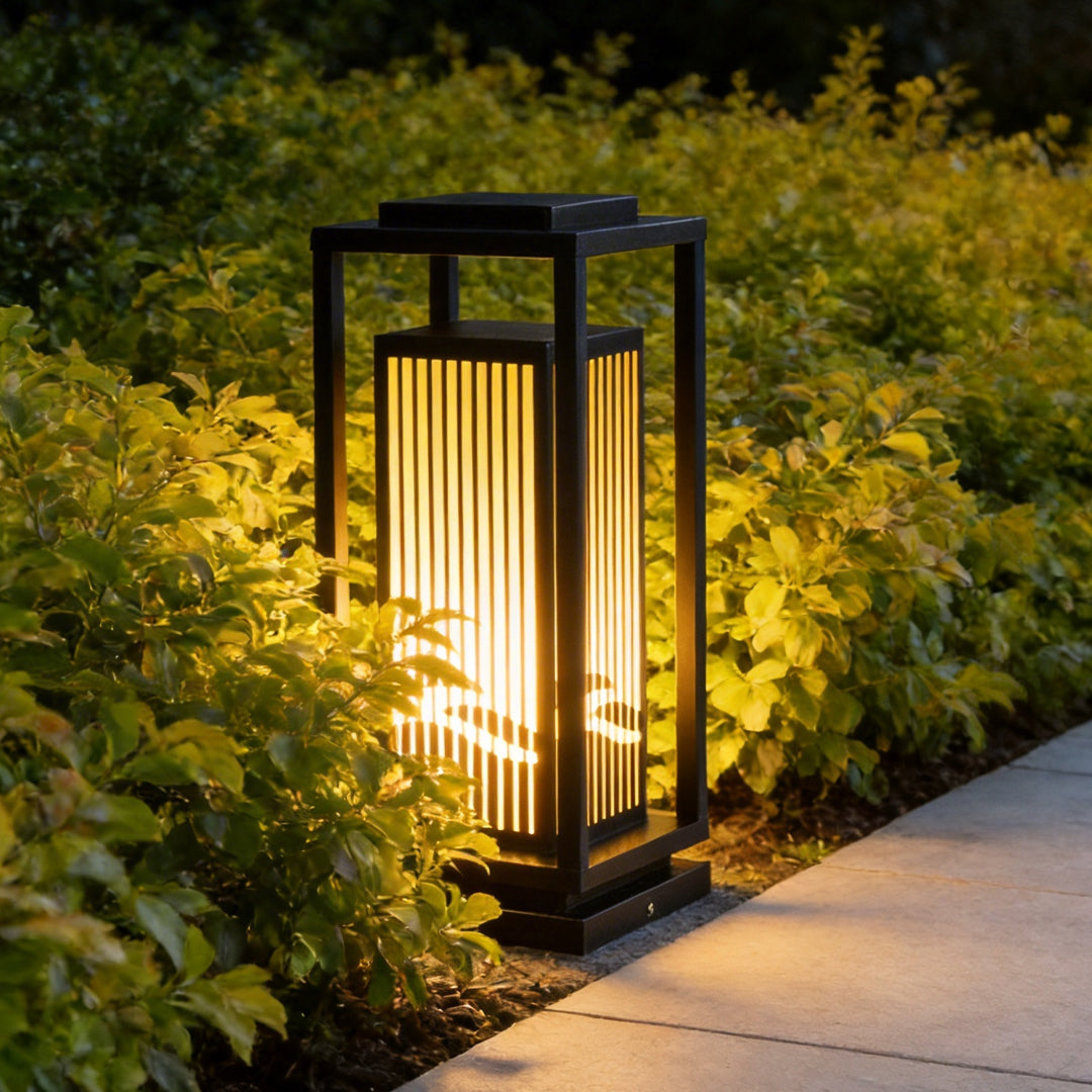 Garden bollards lights with a minimalist design, enhancing a landscaped garden.