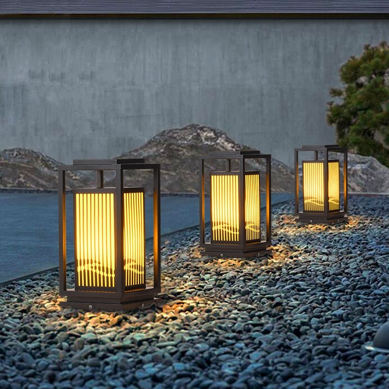 Garden bollards lights with a modern design, installed along a garden path.