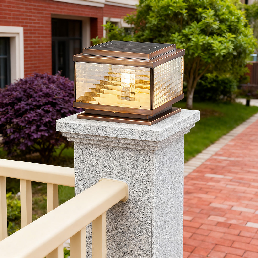 Pillar cap light installed on stone column at garden entrance creating inviting outdoor ambiance.