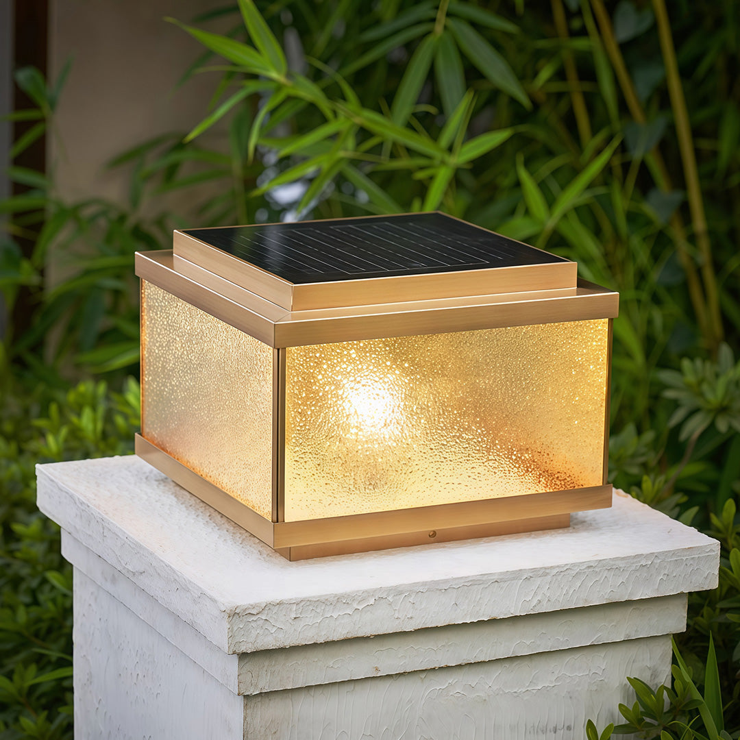Garden pillar lights installed on stone column beside brick pathway creating elegant entrance lighting.
