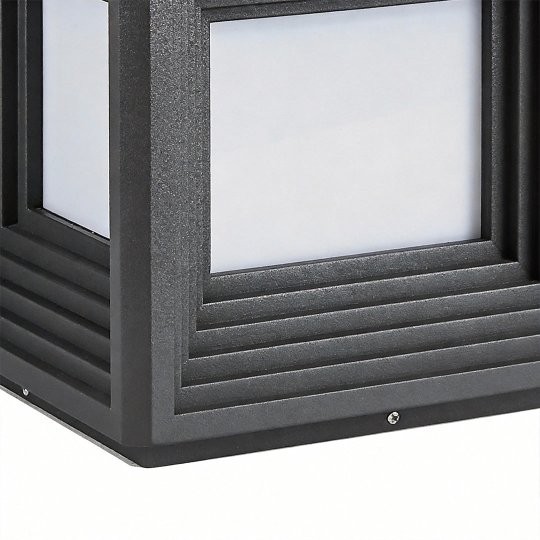 Close-up of gate pillar lights showcasing their layered, cube-like design.
