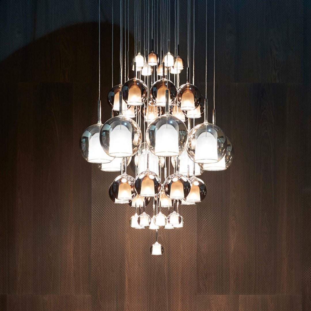 Elegant gathered crystal chandelier with multiple glass ball pendant lights creating dramatic ambient lighting