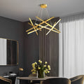 Geometric ceiling light with gold linear LED bars suspended in a modern living room, creating an artistic focal point and warm ambient glow.