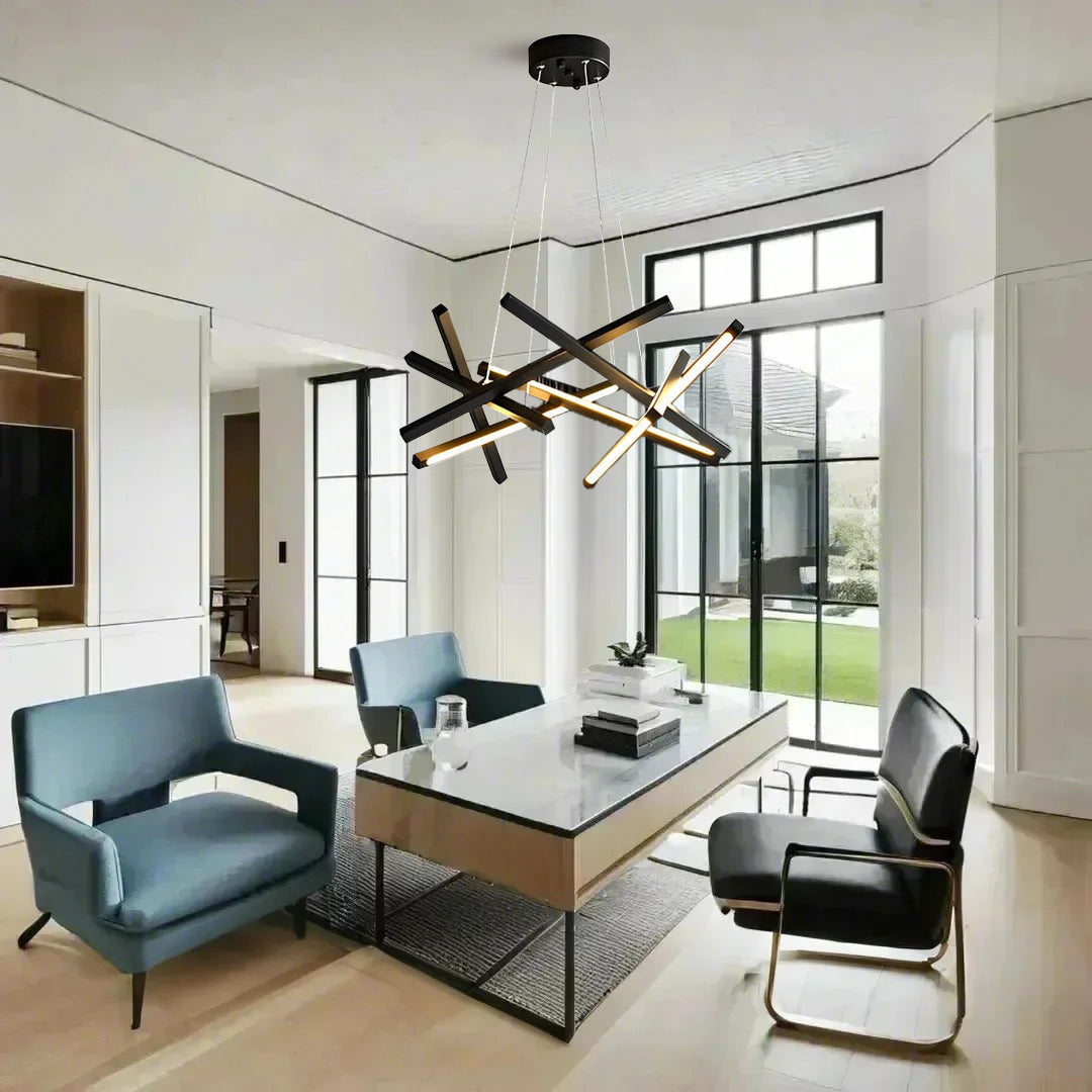 Geometric ceiling light with black and gold intersecting LED bars installed in a bright office space, blending modern design with functionality.