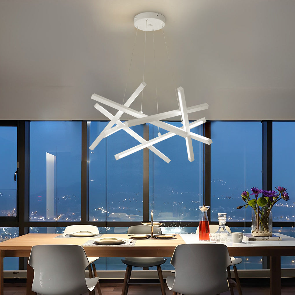 Geometric ceiling light with white linear LED elements suspended over a dining area at night, offering clean lines and contemporary style.