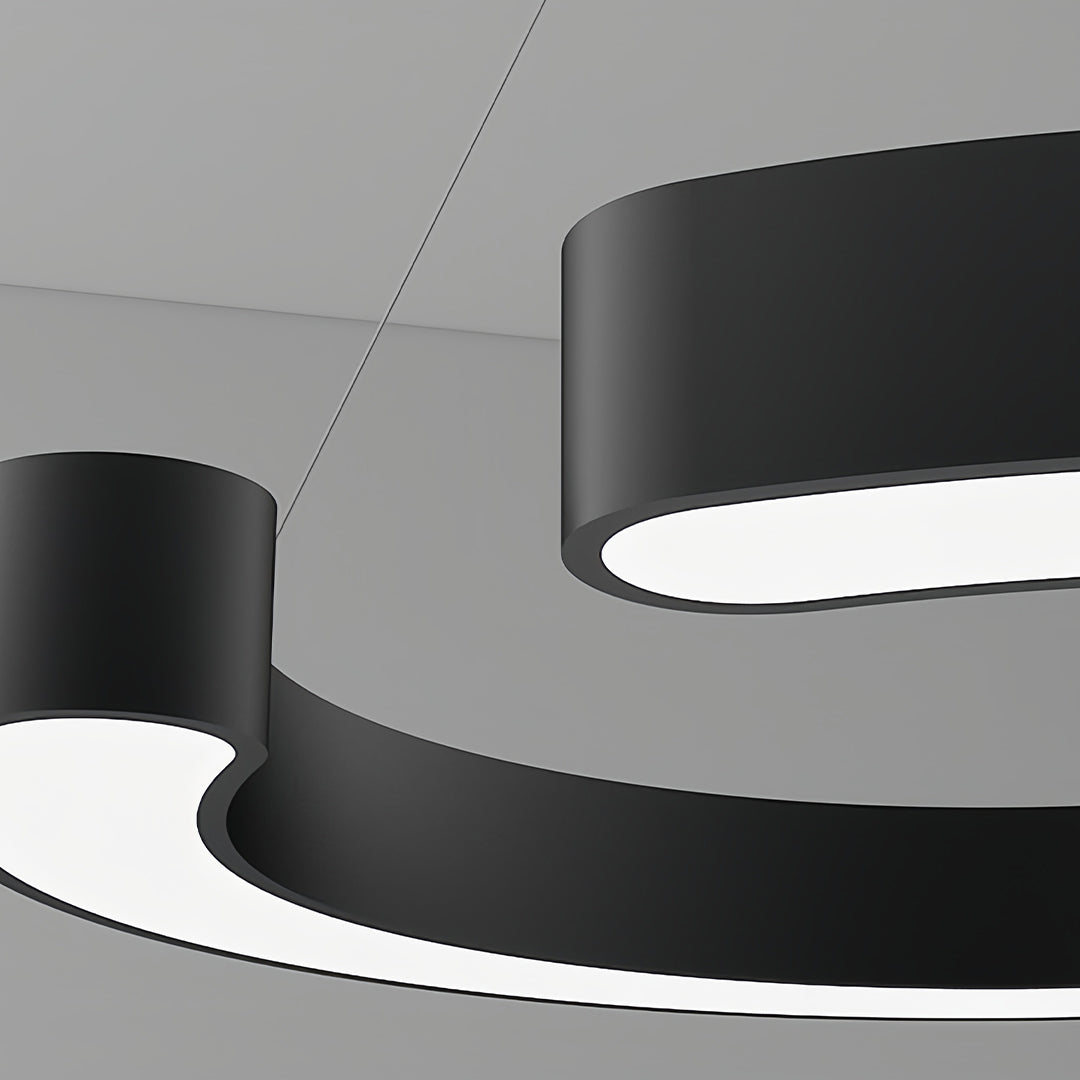 Angled perspective of geometric pendant light highlighting curved form and dual-tone finish