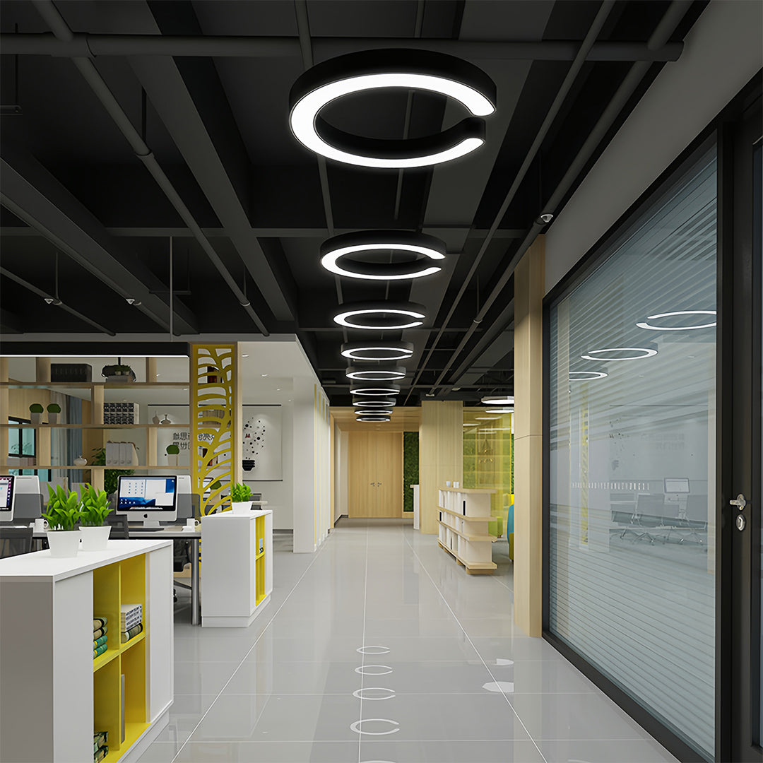 Geometric pendant lights creating dramatic ceiling installation in contemporary commercial hallway
