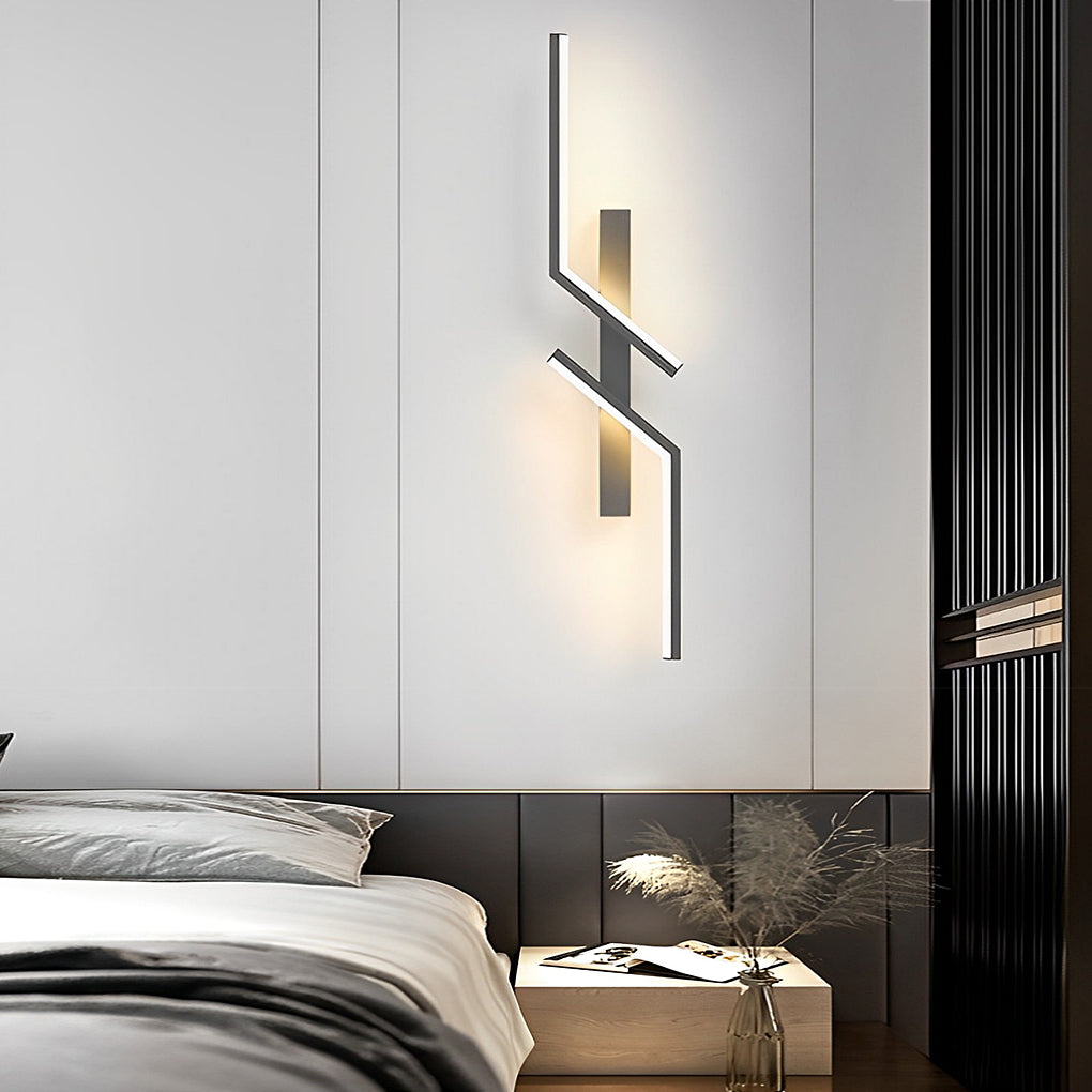 Geometric wall sconce with a minimalist design, installed beside a modern bed.
