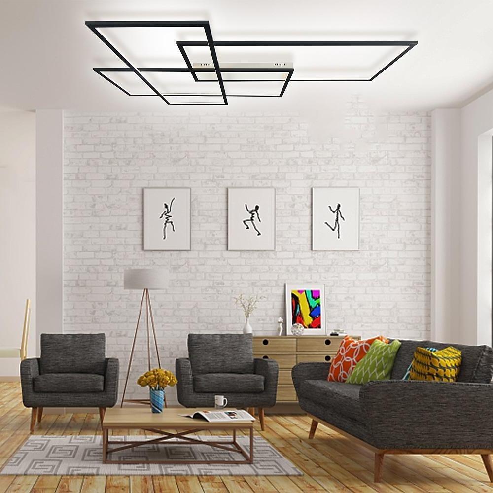 Geometric wall sconce enhancing a stylish living area with gold and black geometric design.