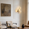 Ginkgo wall light illuminating a modern bedroom with warm ambient glow.