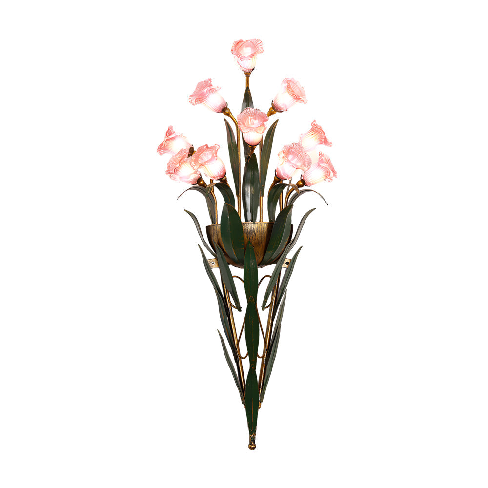Glass flower sconce with white blooms, mounted beside a decorative mirror.