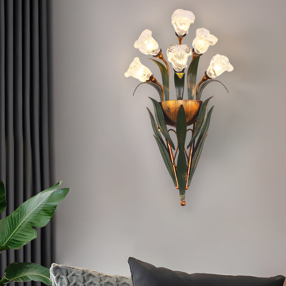 Glass flower sconce with white flowers, enhancing the ambiance of a cozy living space.
