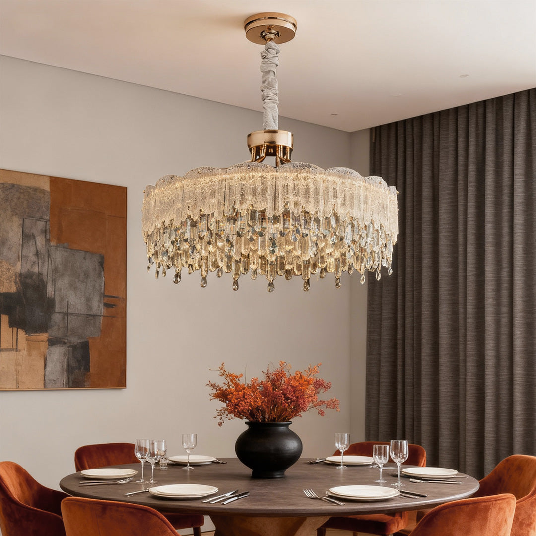 Glass fringe chandeliers brightening dining space with modern marble decor.