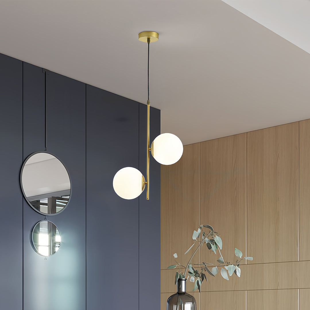 Glass hanging pendant lights in stylish dining room with modern furniture and sleek interior design