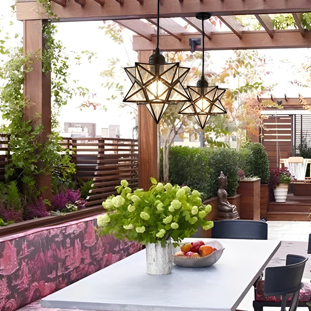 Outdoor glass Moravian star pendant light creating a cozy ambiance in a patio dining area.
