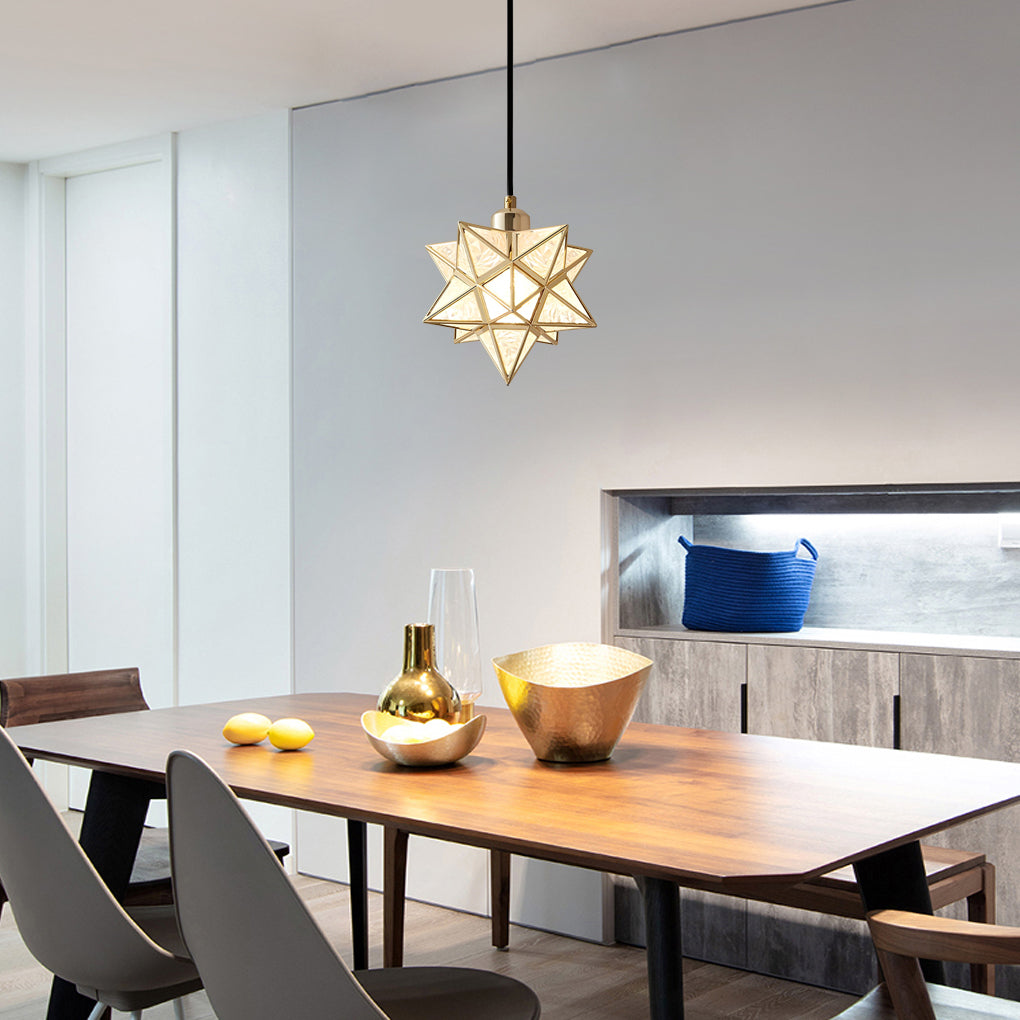 Minimalist glass Moravian star pendant light above a wooden dining table in a modern interior.