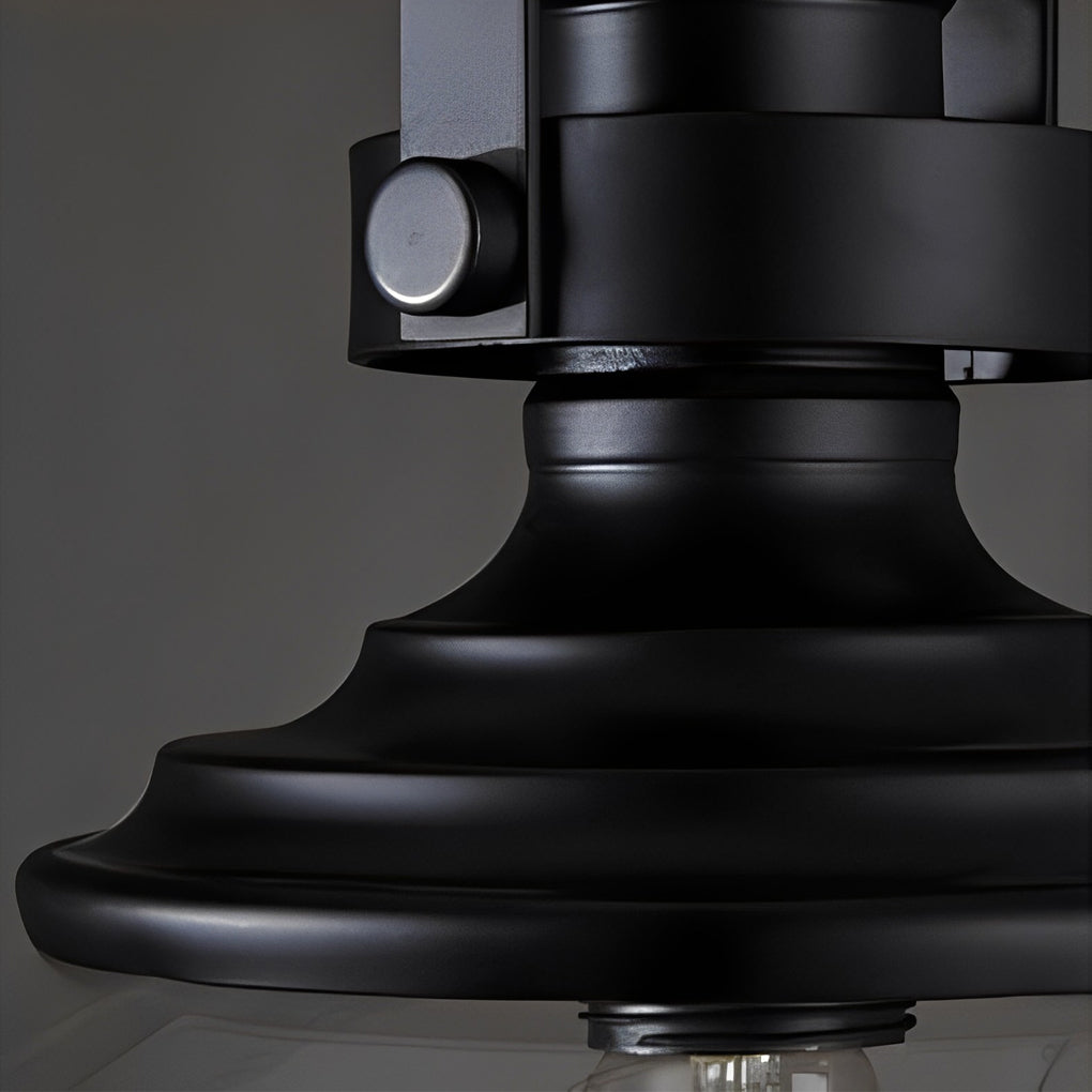 Glass pendant lights kitchen close-up highlighting matte black metal shade and bulb holder design.