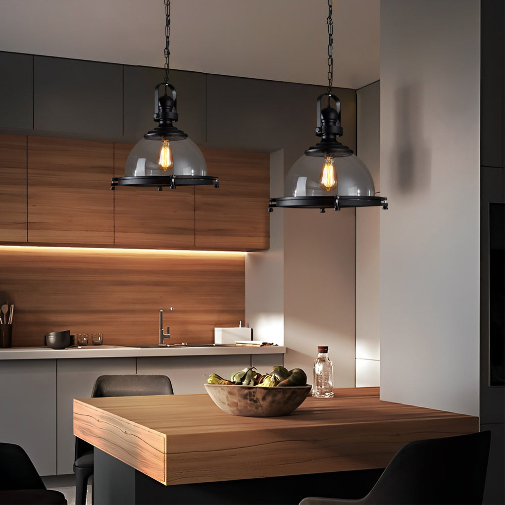 Glass pendant lights kitchen hanging above a modern wooden island with soft ambient lighting.
