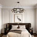 Glass ring chandelier hanging above a modern bedroom with a stylish and elegant design.
