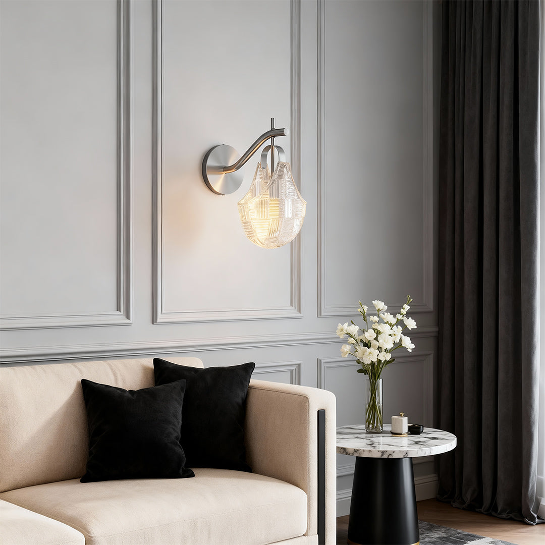 Glass wall sconces providing ambient lighting in contemporary bedroom with beige tones