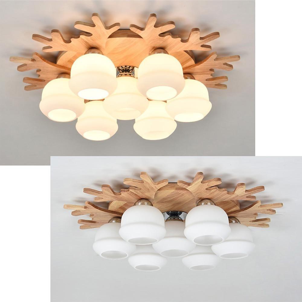 Close-up view of wooden base and frosted glass globes on a modern globe ceiling lamp.