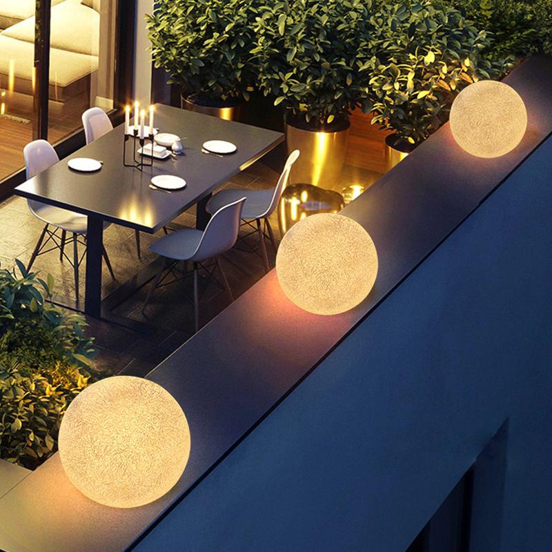 Globe pillar lights mounted along an outdoor balcony railing