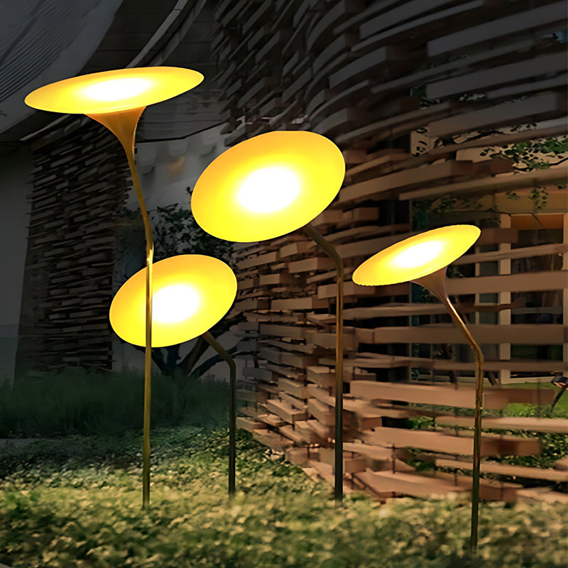 Glowing mushroom garden light illuminating a cluster of lights in a night garden.