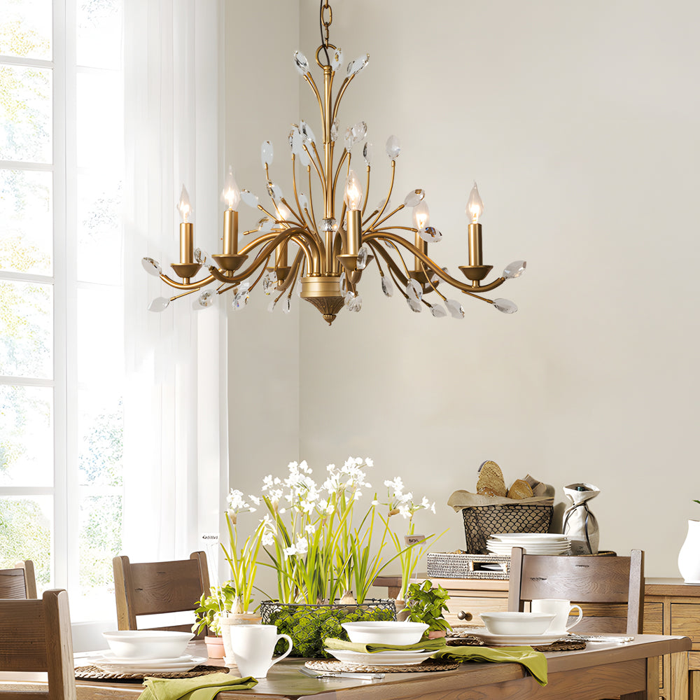 Gold candlestick chandelier with a close-up of its candle-style bulbs and gold branches.