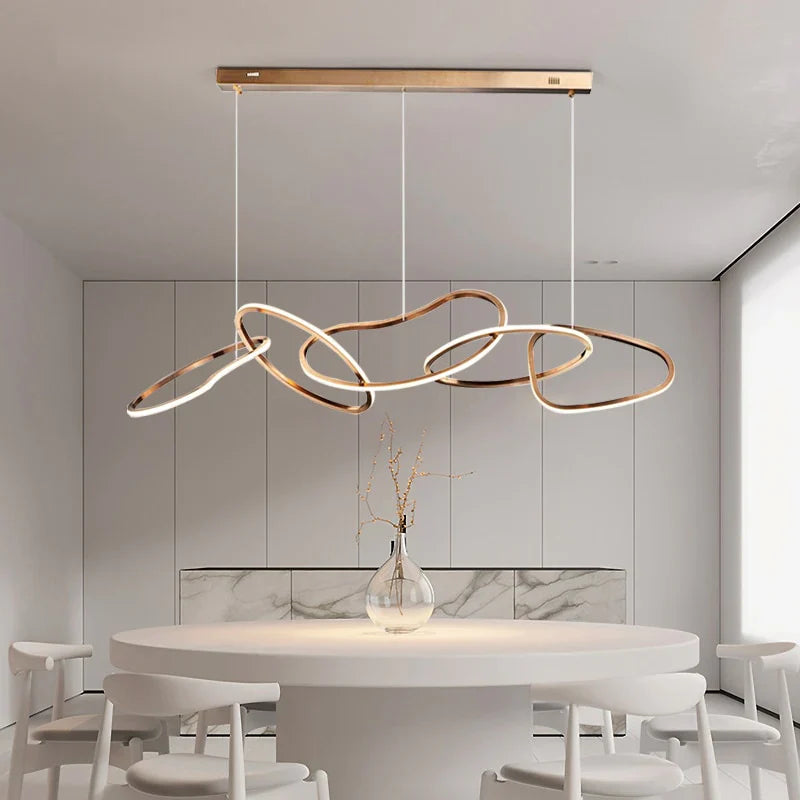 Gold circle chandelier with a golden finish, enhancing a sophisticated dining room.