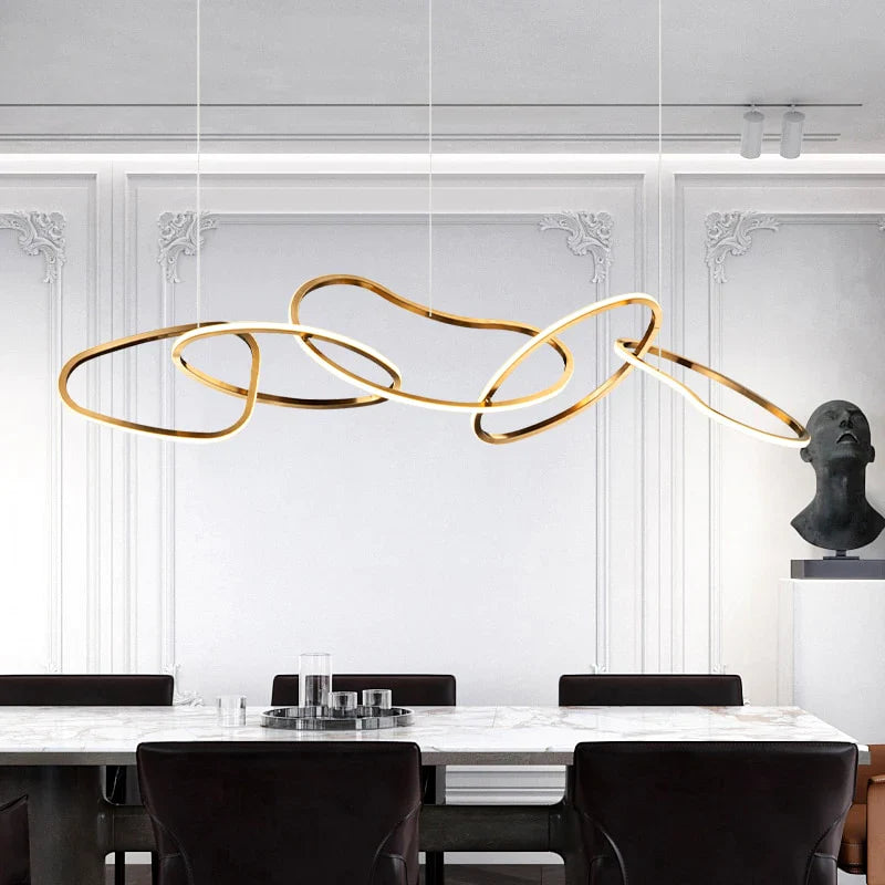Gold circle chandelier with a minimalist design, providing warm light in a modern living room.