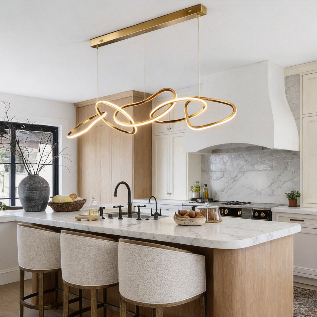 Gold circle chandelier with a sleek design, enhancing a stylish kitchen island.