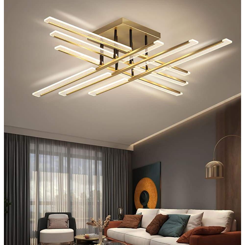 Gold cross ceiling light used in a modern living room with layered ceiling lighting.
