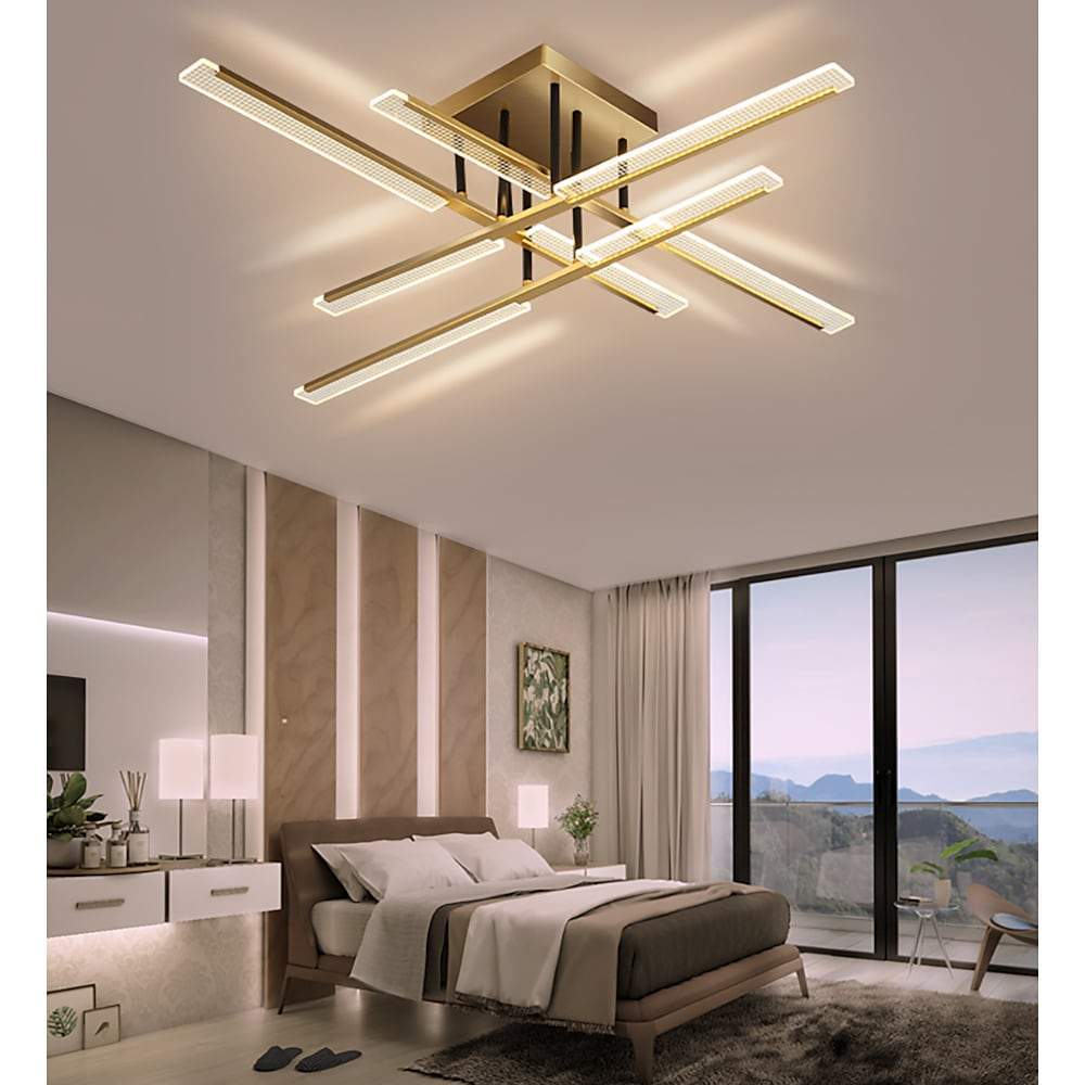 Gold cross ceiling light mounted in a modern bedroom with floor-to-ceiling windows.