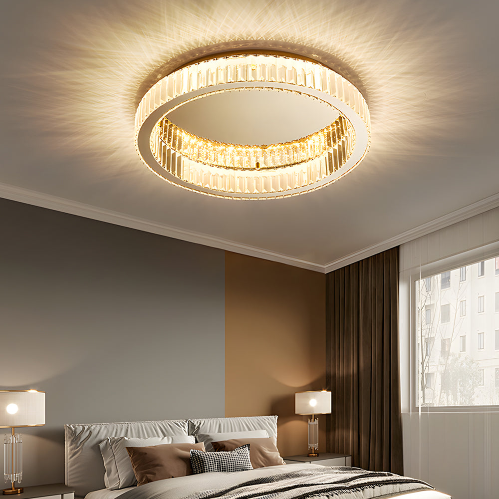 Gold crystal ring ceiling light mounted in an elegant bedroom interior.
