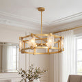 Elegant gold round glass chandelier featuring a drum frame with textured clear glass panels in a sophisticated room.
