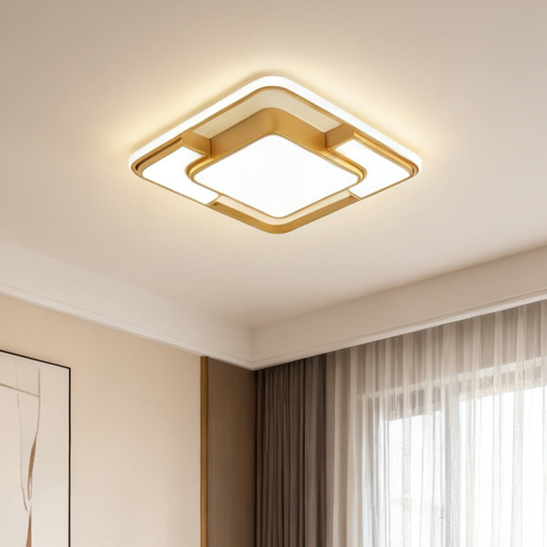 Gold flush mount square ceiling light installed in a bedroom with soft natural daylight