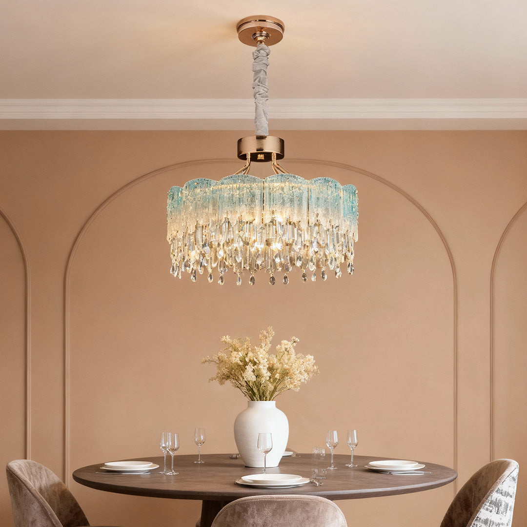 Round gold glass fringe chandeliers adding luxury glow to dining area.