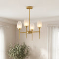 Elegant gold glass modern chandelier featuring frosted tulip-shaped shades and sleek tapered stems in a bright, contemporary room.