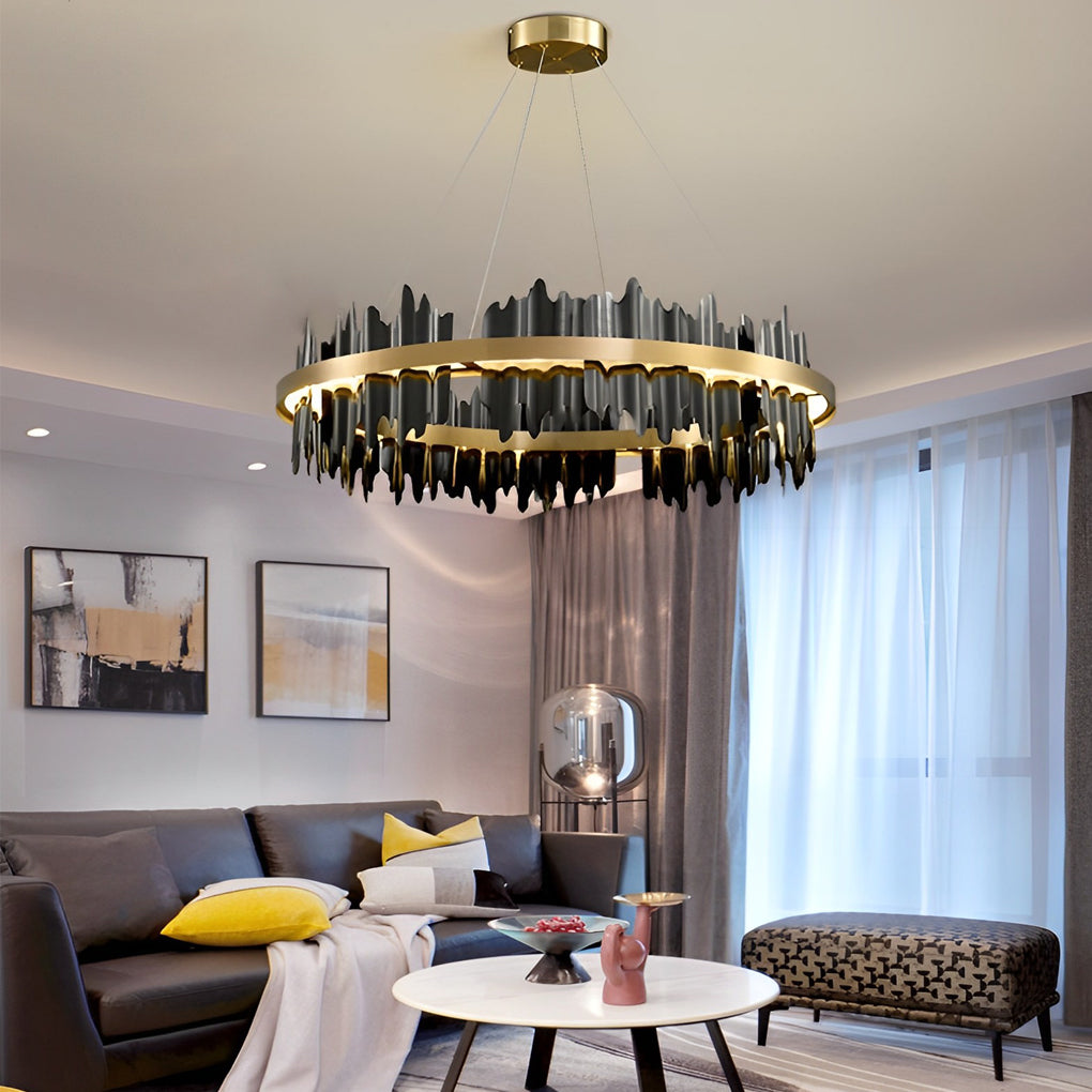 Gold leaf chandelier with a modern design, hanging above a dining table.