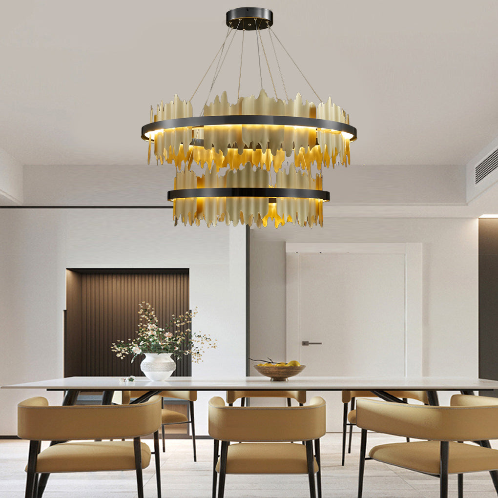 Gold leaf chandelier providing warm lighting in a cozy living room setting.