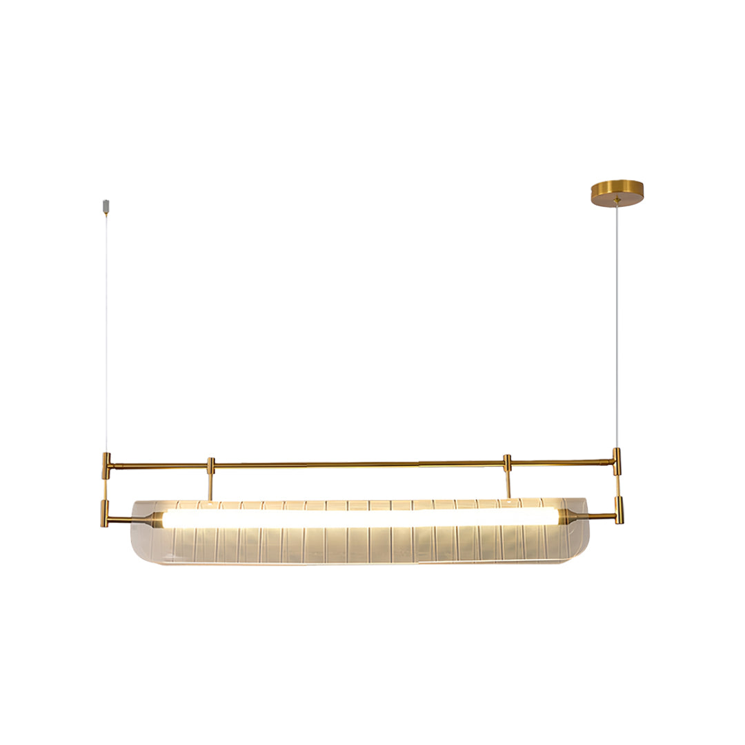 Gold linear light pendant with ribbed glass diffuser suspended by thin cables on white background.