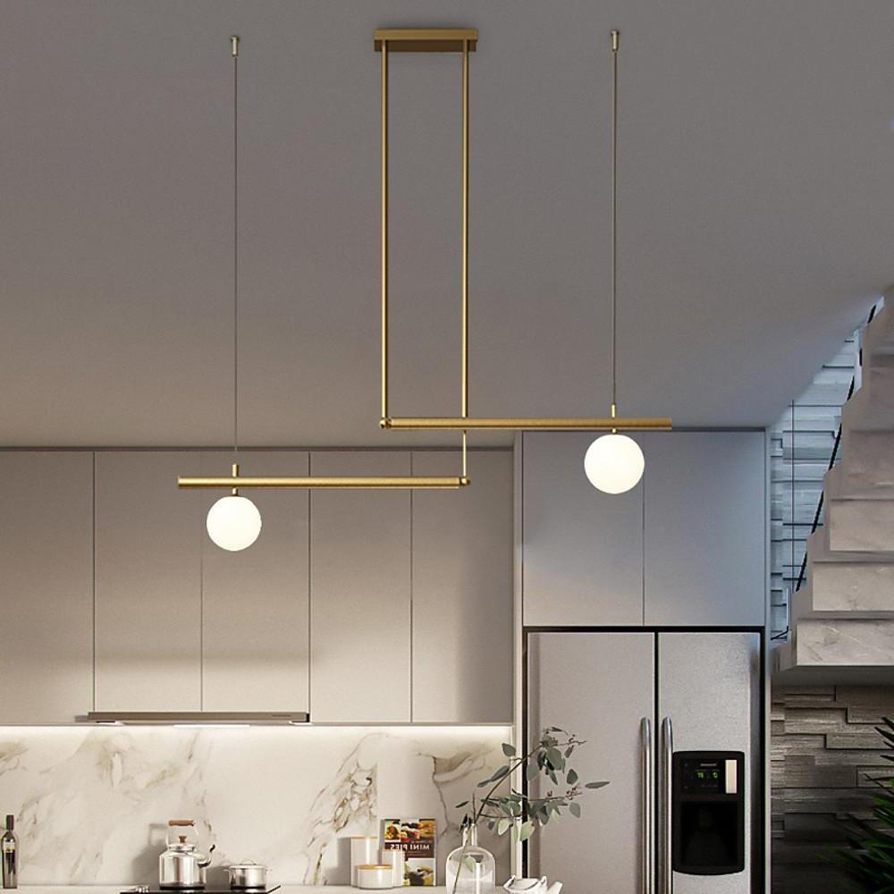 Gold linear pendant light with adjustable hanging rods in kitchen.