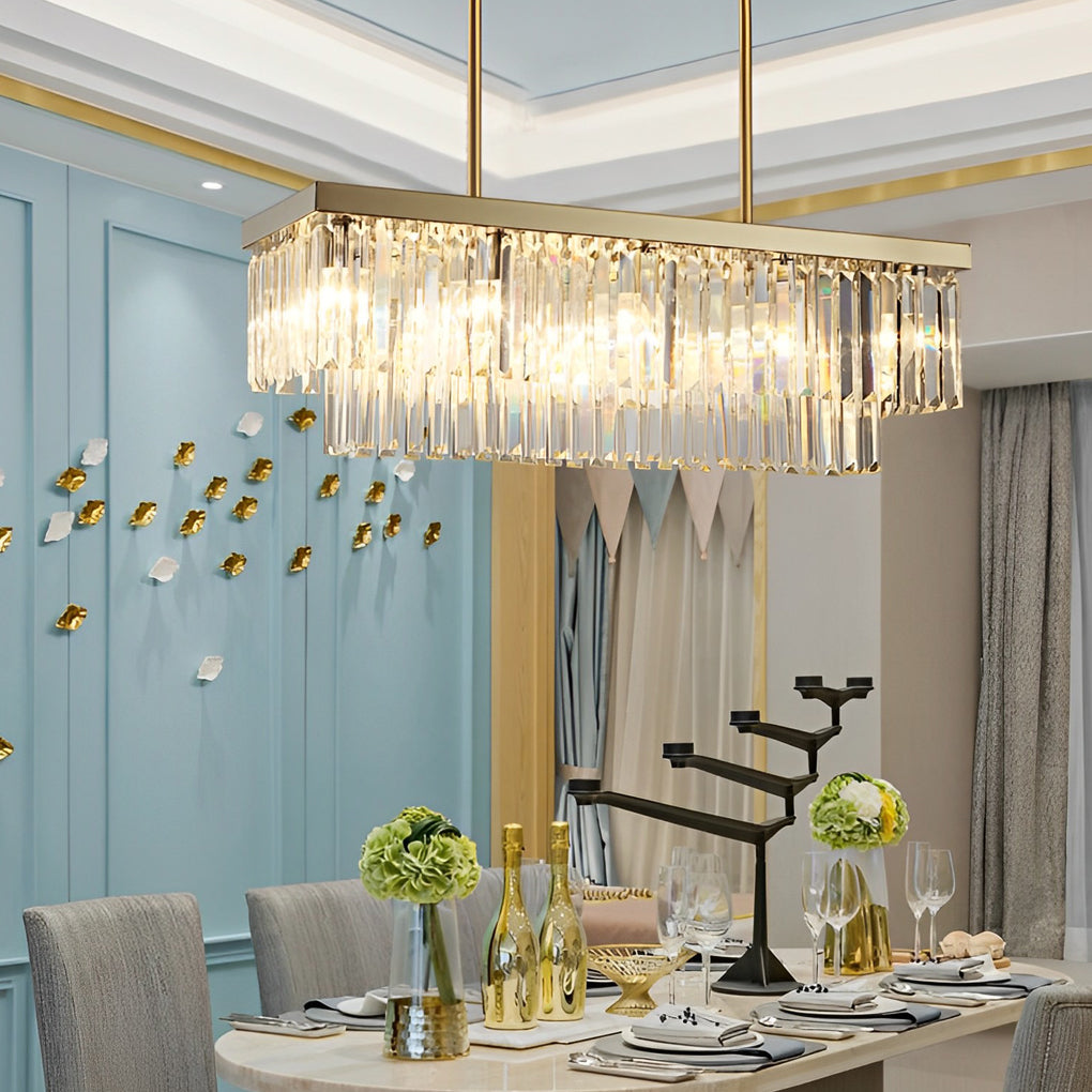 Gold rectangular chandelier with a minimalist design, installed above a dining table.