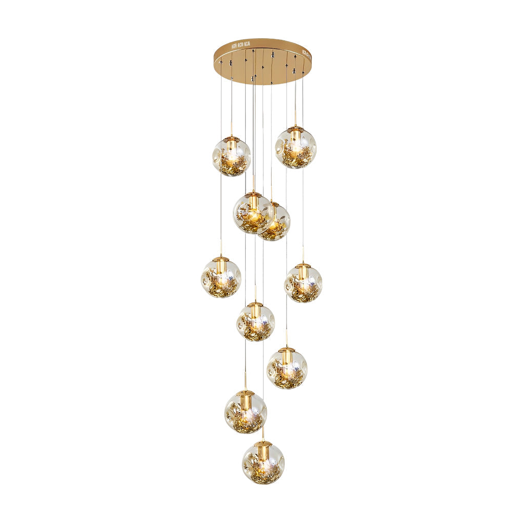 Gold staircase chandelier with a close-up of its illuminated crystal globes.
