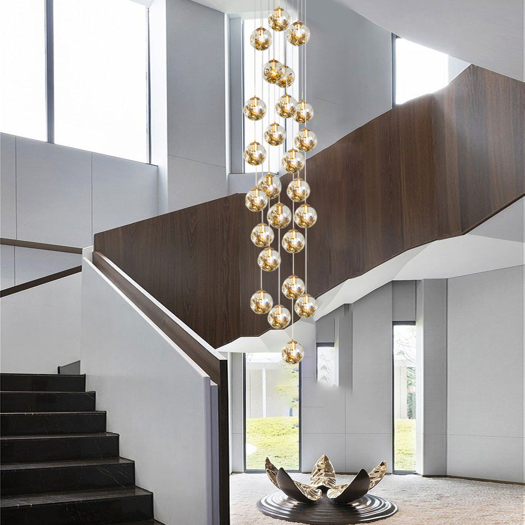 Gold staircase chandelier with a close-up of its intricate crystal and gold chain design.