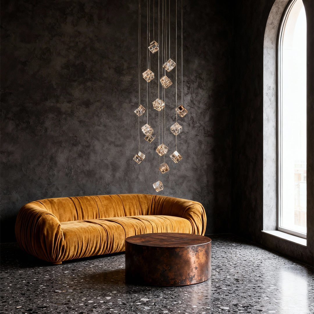 Gold cube stairs chandelier suspended beside curved staircase in luxury foyer.
