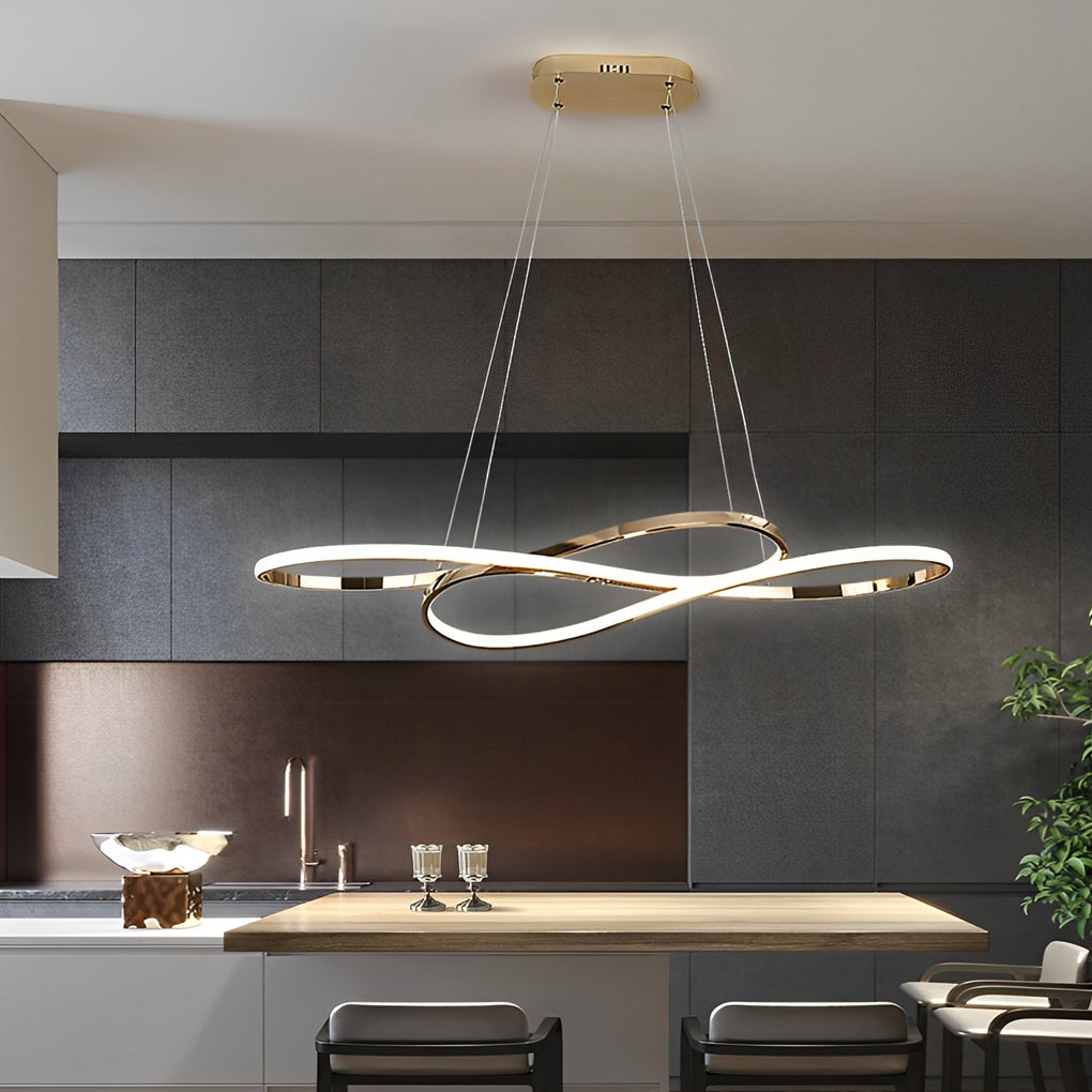 LED infinity chandelier with golden finish hanging above dining table.