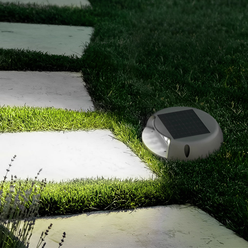 LED deck pathway lighting installed along grass and stone path, providing warm and inviting garden pathway illumination