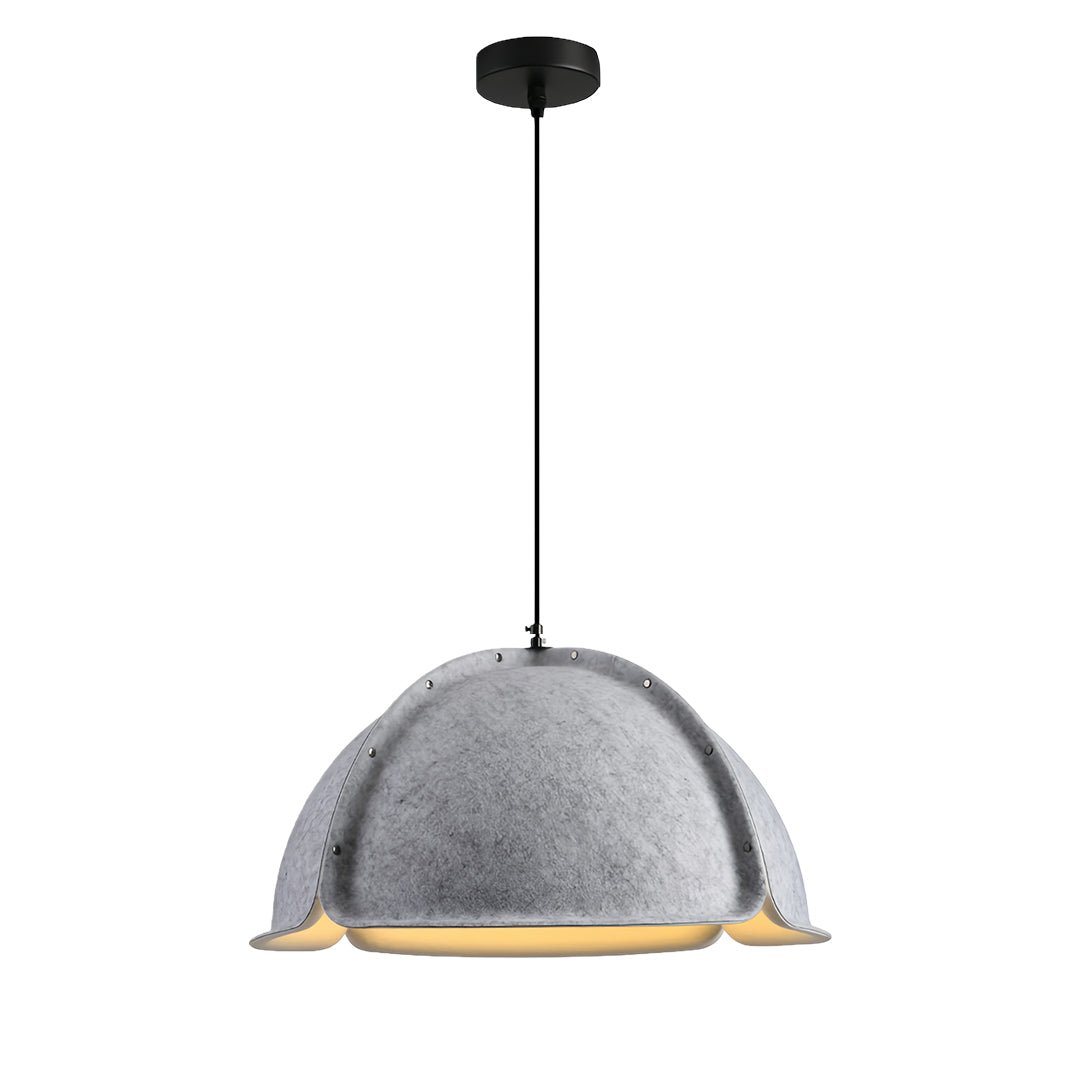 Group of colored pendant light fixtures with gray slat shades suspended over a long communal wooden table in a library.